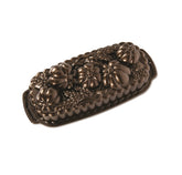 Nordic Ware vue avant du moule montrant motifs et finition bronze