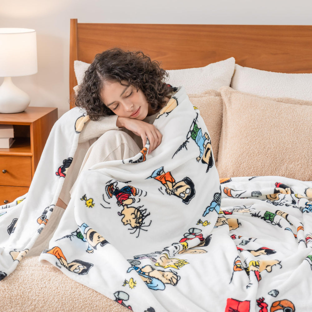 Berkshire Blanket enfant sur lit avec Snoopy, offre chaleur rassurante