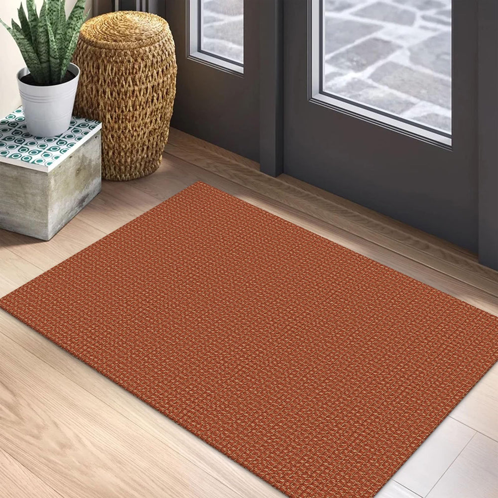 Tapis EARTHALL posé face à la porte apportant chaleur et confort