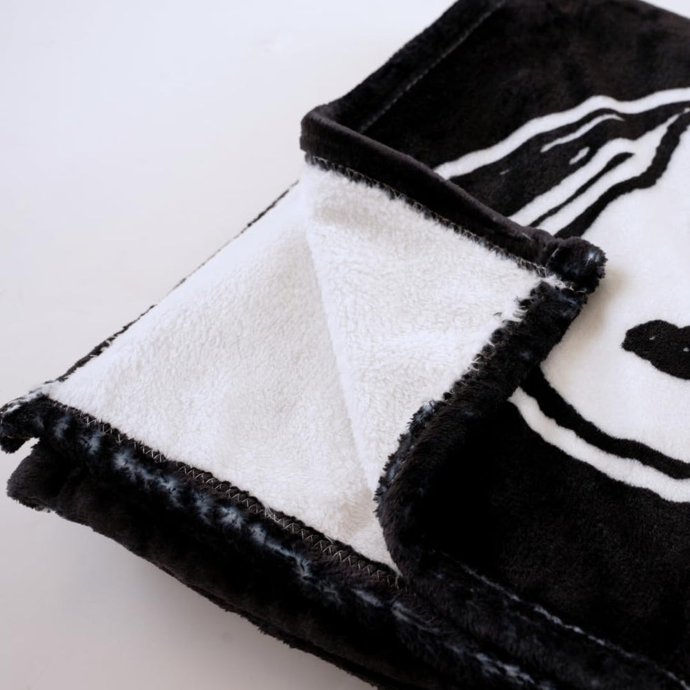 Franco Snoopy plié dans valise illustrant portabilité pratique
