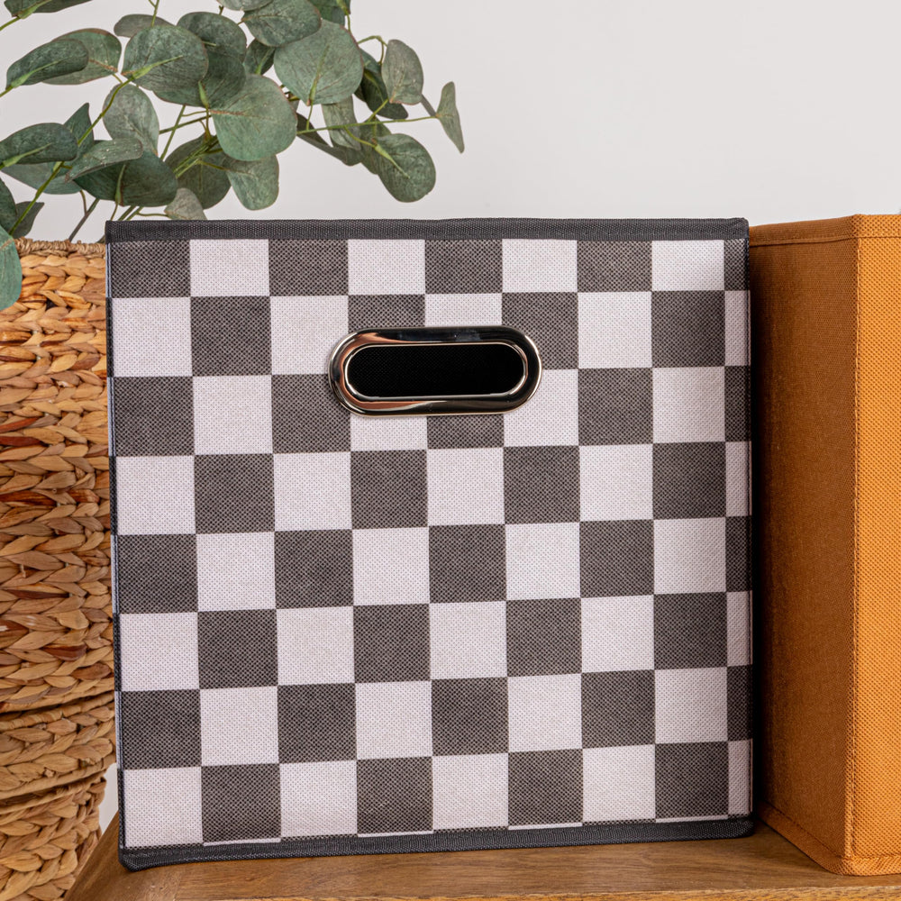 Household Essentials cube à côté d'un livre, montre l'échelle pratique