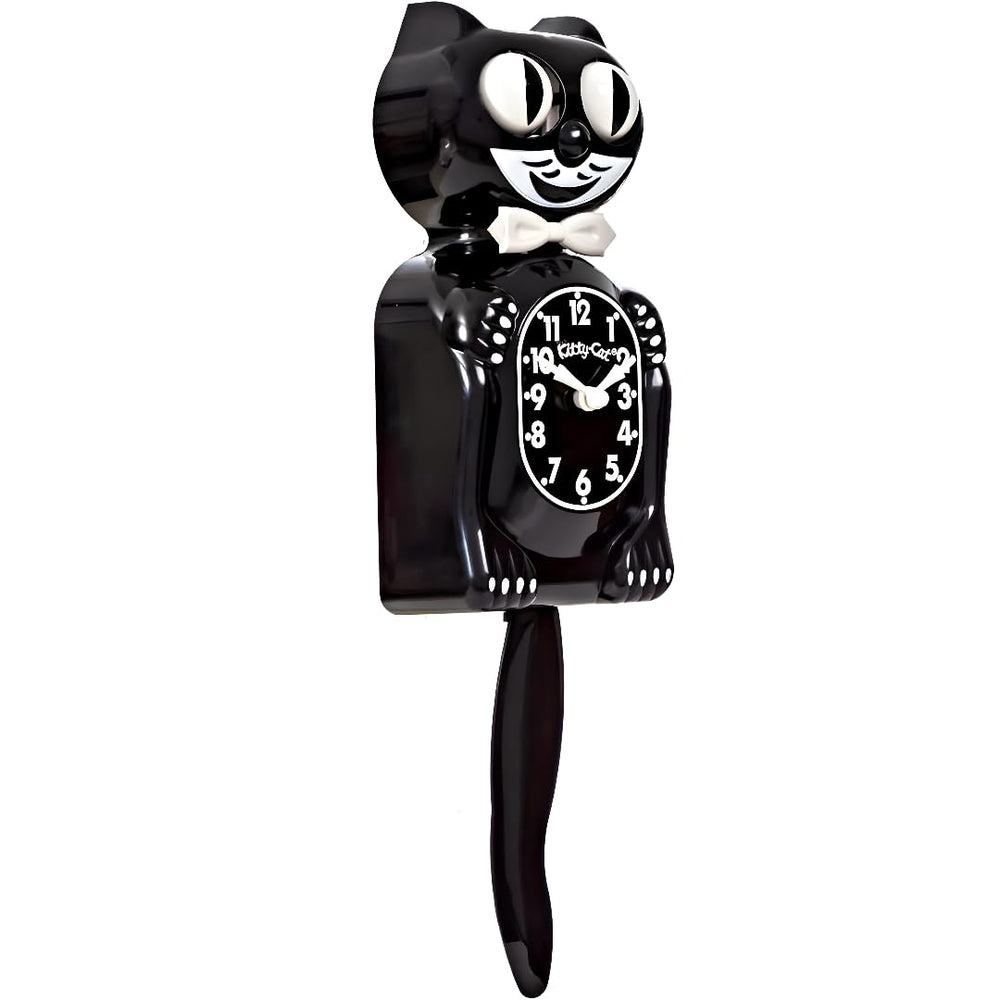 Kit Cat Klock placé à côté d'un livre illustrant l'échelle et la taille compacte pratique