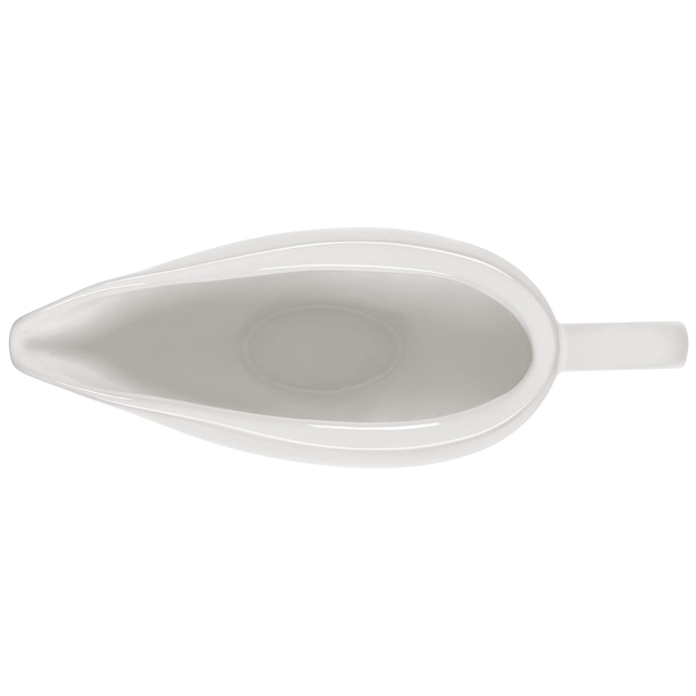 Le Creuset saucière en usage versant une sauce avec contrôle et sans gouttes