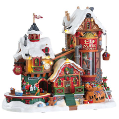 Lemax usine de jouets façade avant éclairée montrant détails architecturaux et ambiance