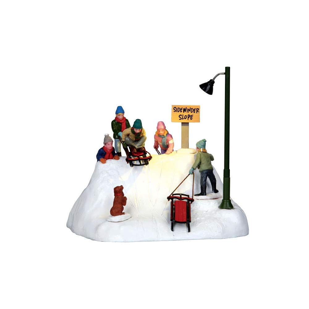 Lemax Ready to Launch intégré dans un village de Noël, ajoutant vie et luminosité