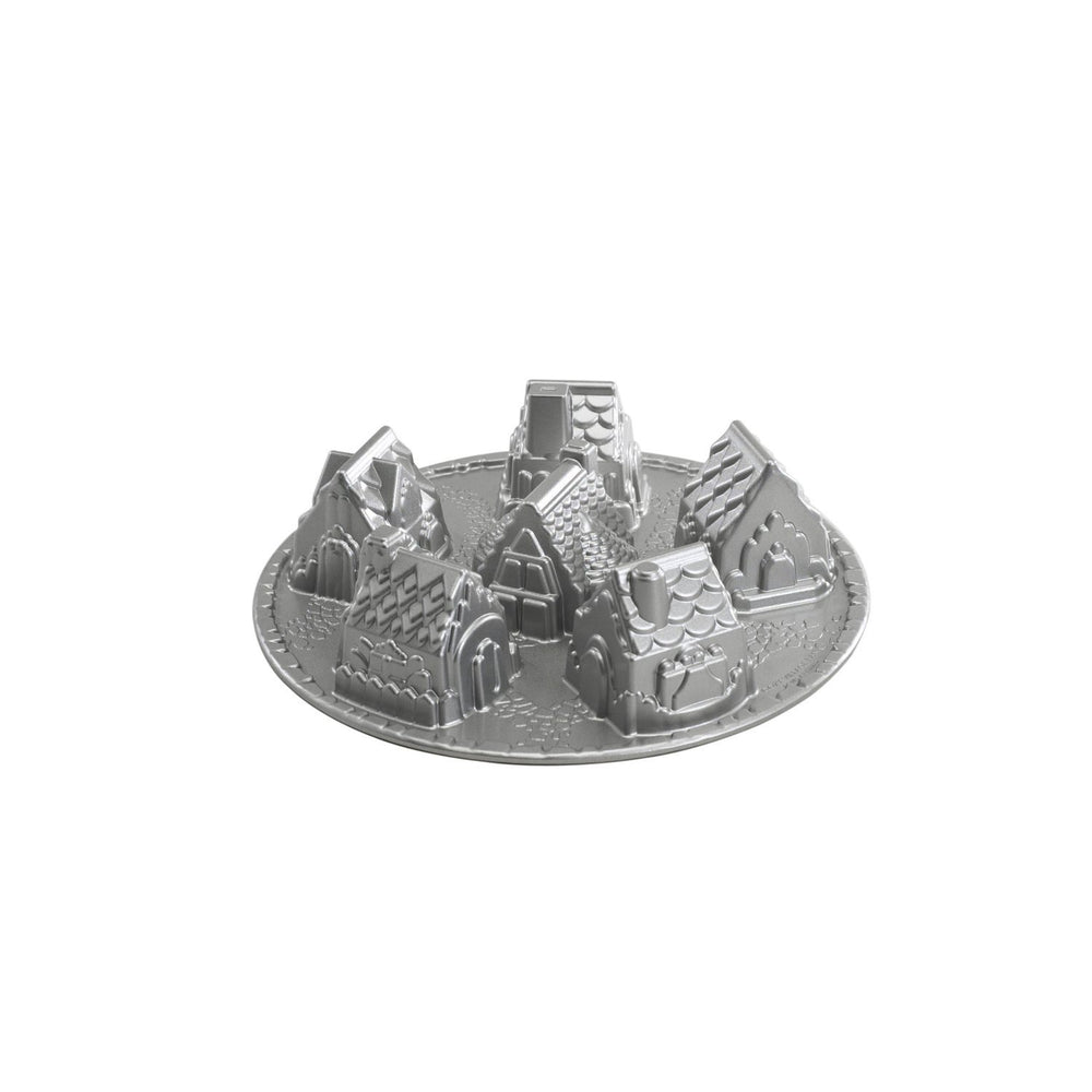 Nordic Ware moule Cozy Village vue avant emballage montrant six maisons, facilite créations festives
