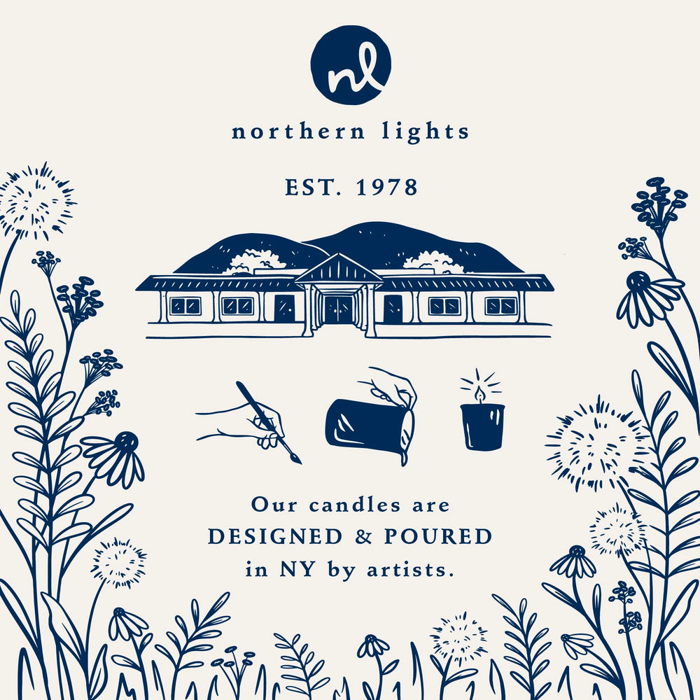 Northern Lights Candles bougie placée à côté d'une main pour évaluer la taille compacte
