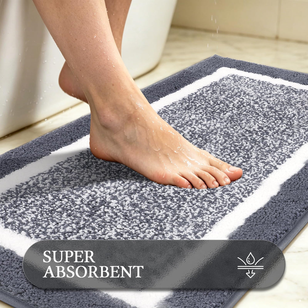 Tapis long Pauwer placé devant la baignoire pour absorption efficace