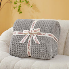 Snuggle Sac plaid sur canapé montrant confort et style
