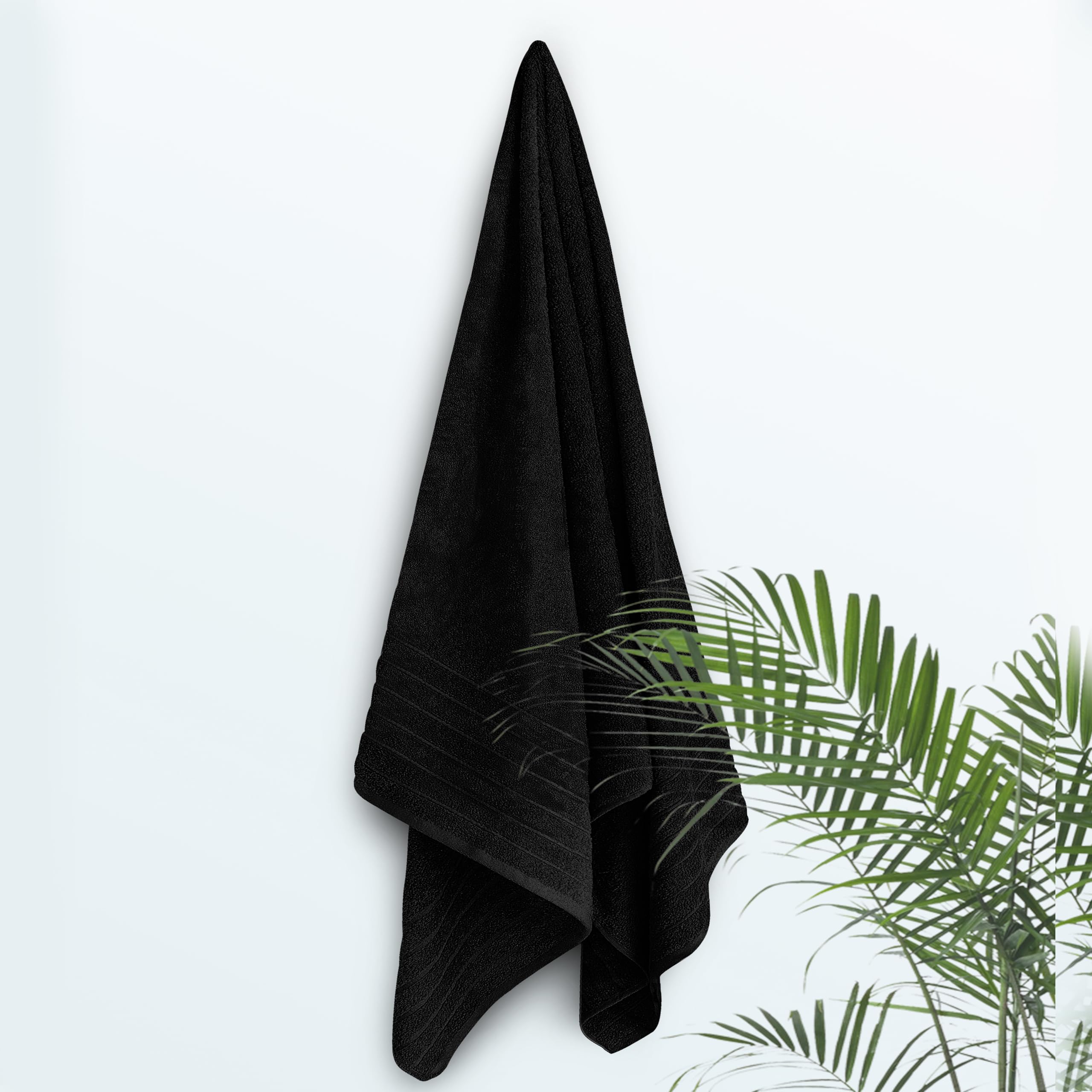 Tens Towels drap comparé à une personne illustrant dimensions 40 x 80 pouces pratiques
