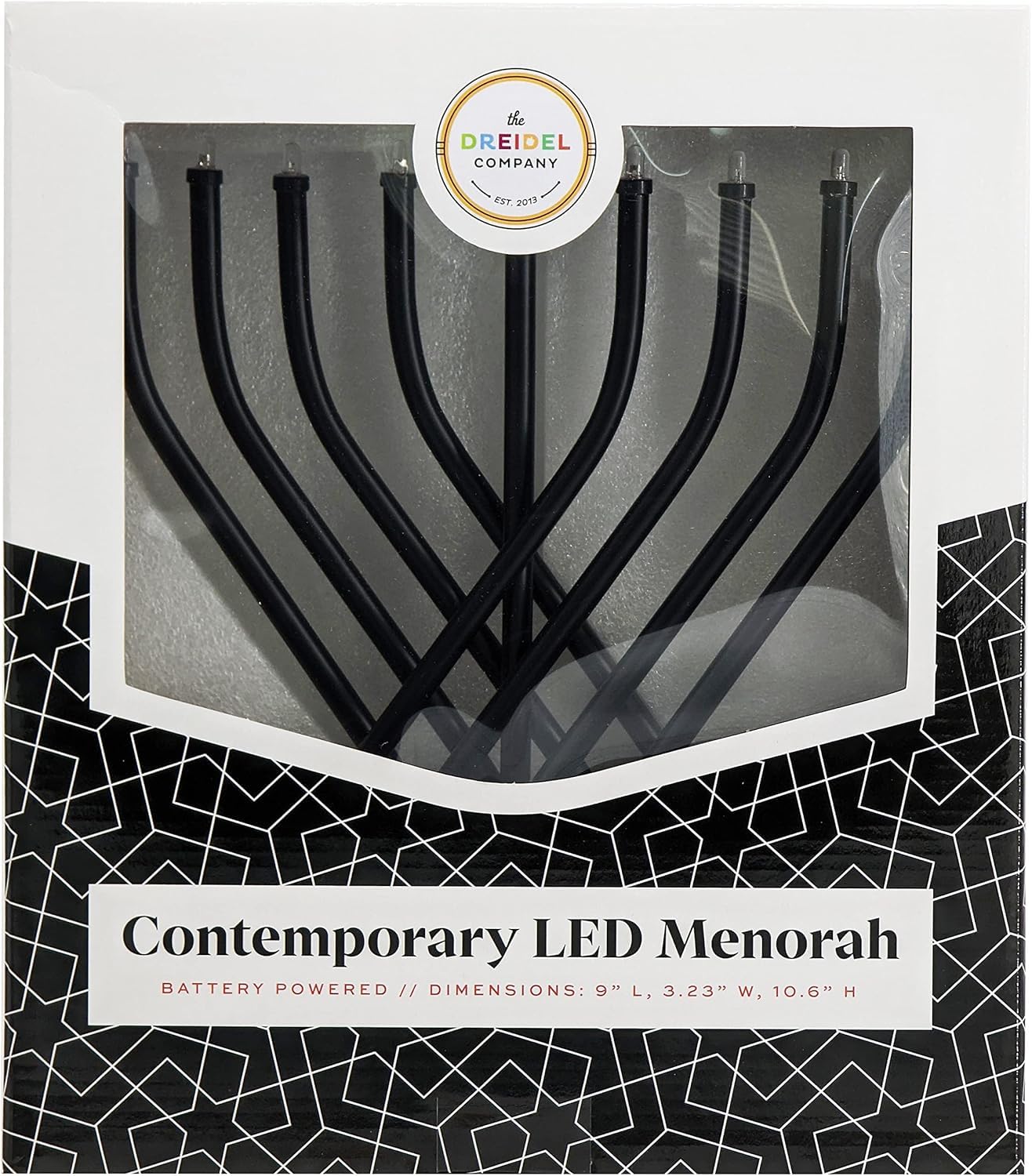 The Dreidel Company menorah à côté d’un livre pour comparaison de taille, compacte et pratique